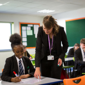 Photo of a teacher helping a student