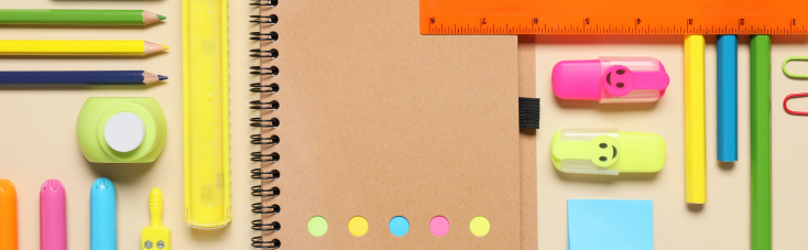 An illustration of stationery laid in a pattern including a notepad and pens